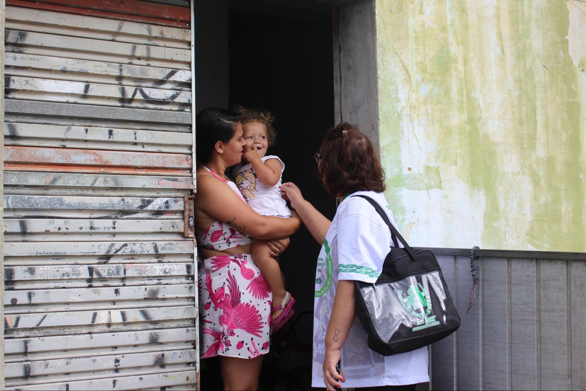 Líder da Pastoral da Criança acompanha mãe e criança durante visita domiciliar à família