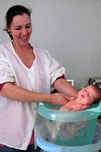 enfermeira dando banho em bebê recem nascido
